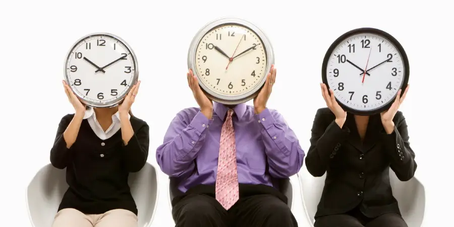 3 business people with clocks as faces - time contraints