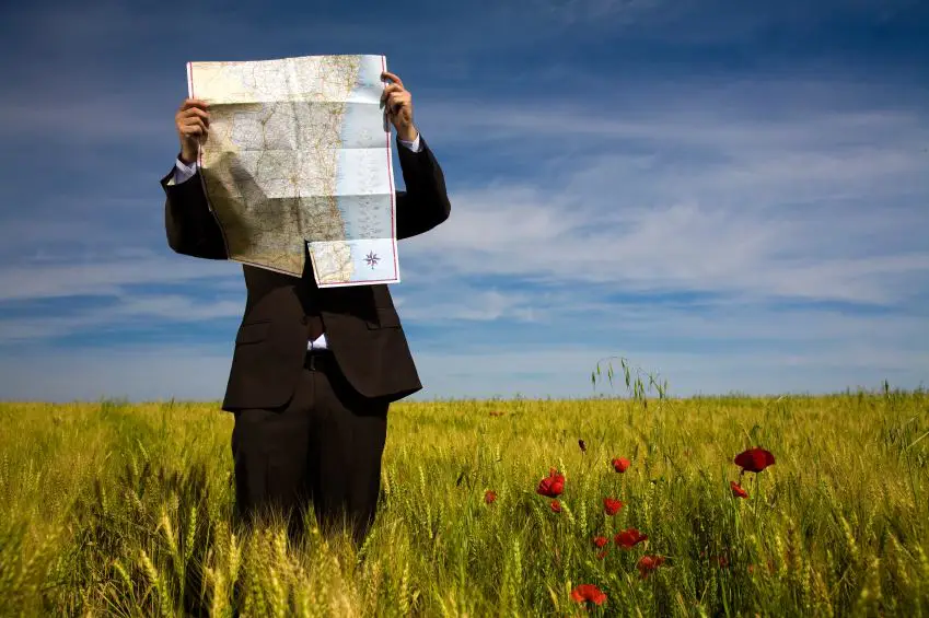 Man looking at a map in an open field